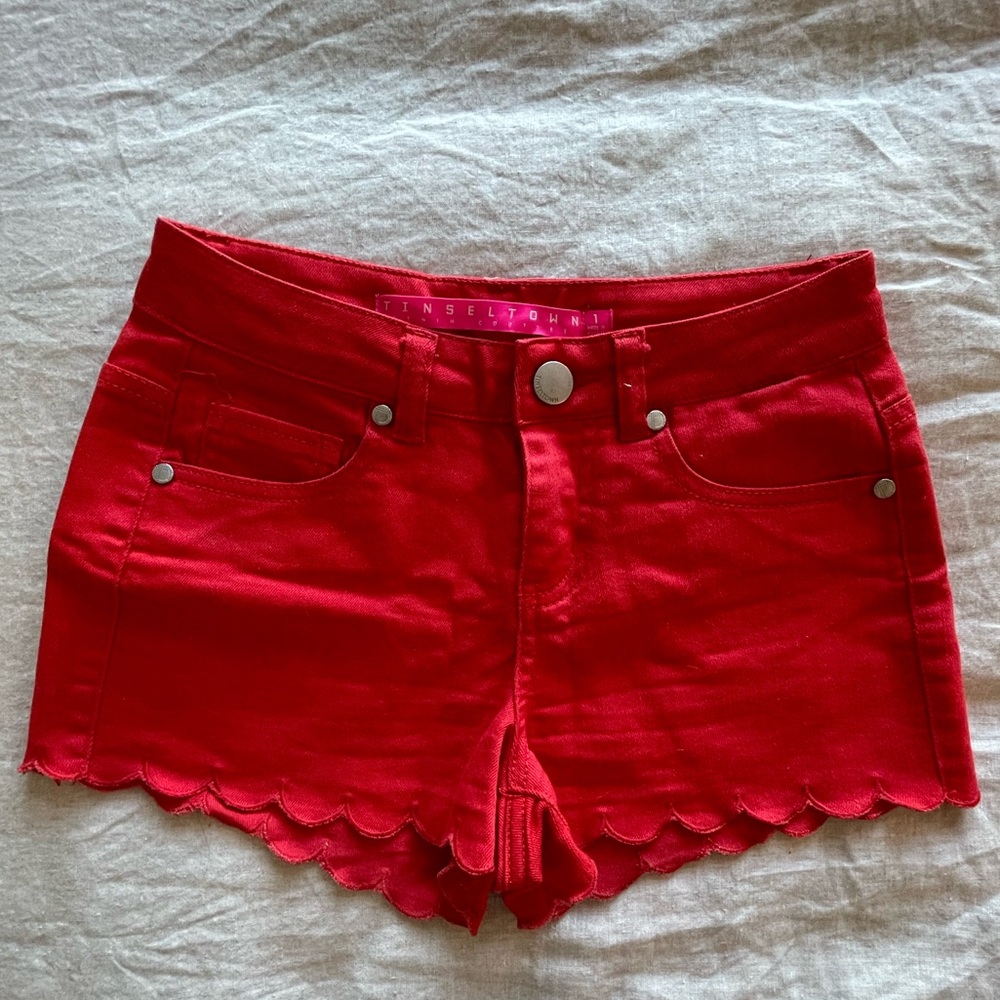 Red denim shorts with scalloped bottoms